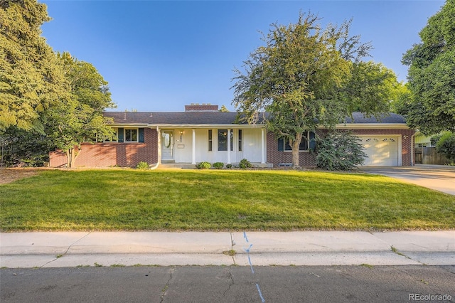 5857 S Logan Ct, Centennial, CO 80121 - single story home with brick siding, a front yard, concrete driveway, a chimney, and an attached garage