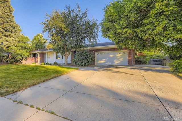 5857 S Logan Ct, Centennial, CO 80121 - view of front facade featuring brick siding, a garage, and driveway