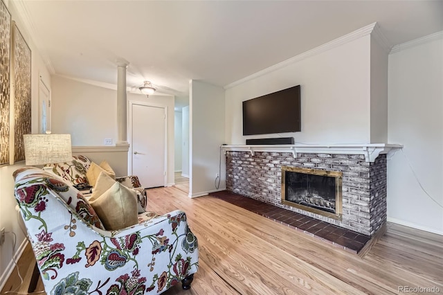 5857 S Logan Ct, Centennial, CO 80121 - living area with ornamental molding, wood finished floors, and a fireplace