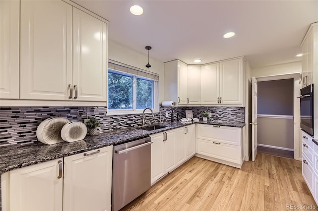 5857 S Logan Ct, Centennial, CO 80121 - kitchen with appliances with stainless steel finishes, white cabinetry, decorative backsplash, light wood-type flooring, and recessed lighting