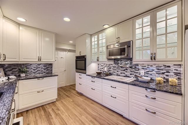 5857 S Logan Ct, Centennial, CO 80121 - kitchen featuring stainless steel appliances, tasteful backsplash, white cabinetry, recessed lighting, and light wood-style floors