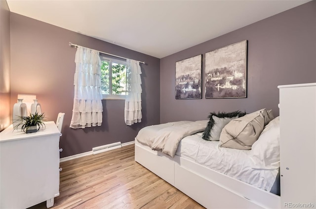 5857 S Logan Ct, Centennial, CO 80121 - bedroom with wood finished floors and a baseboard radiator