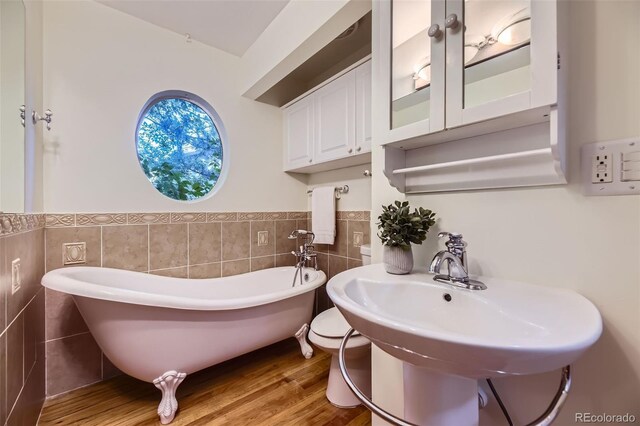 5857 S Logan Ct, Centennial, CO 80121 - full bath with tile walls, a freestanding bath, wainscoting, and wood finished floors