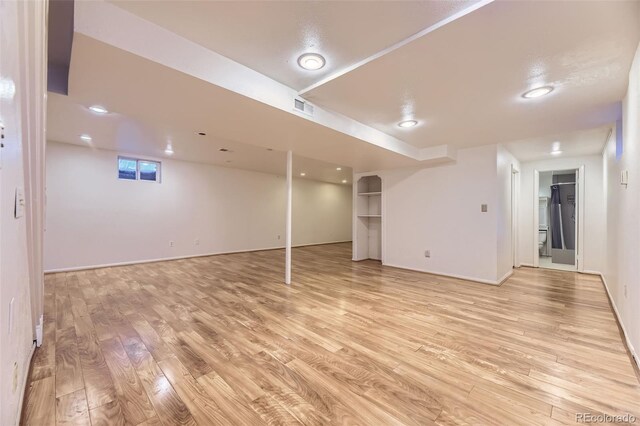 5857 S Logan Ct, Centennial, CO 80121 - finished basement featuring light wood-style floors and baseboards