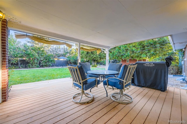 5857 S Logan Ct, Centennial, CO 80121 - wooden terrace with grilling area, a fenced backyard, and outdoor dining area