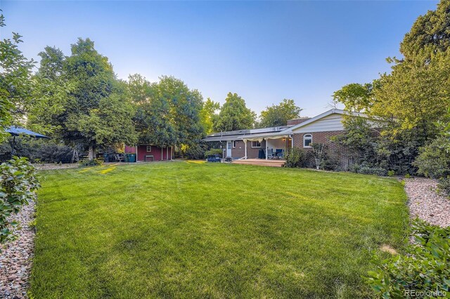 5857 S Logan Ct, Centennial, CO 80121 - view of green lawn with a wooden deck