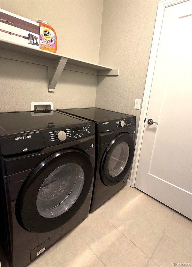 4680 Copeland Loop Unit 203, Highlands Ranch, CO 80126 - laundry area with independent washer and dryer and light tile patterned floors