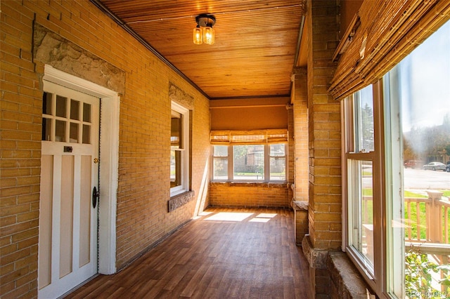 unfurnished sunroom featuring wooden ceiling