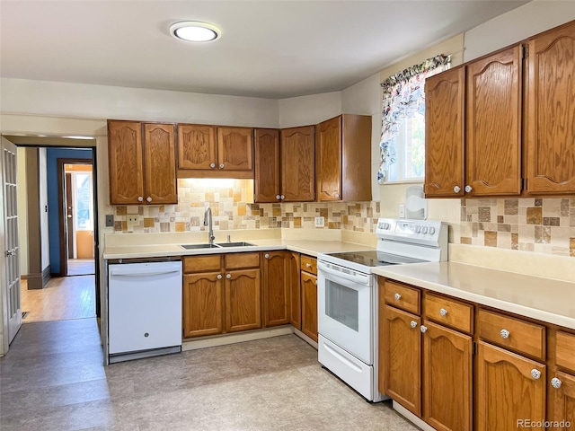 kitchen featuring tasteful backsplash, sink, and white appliances