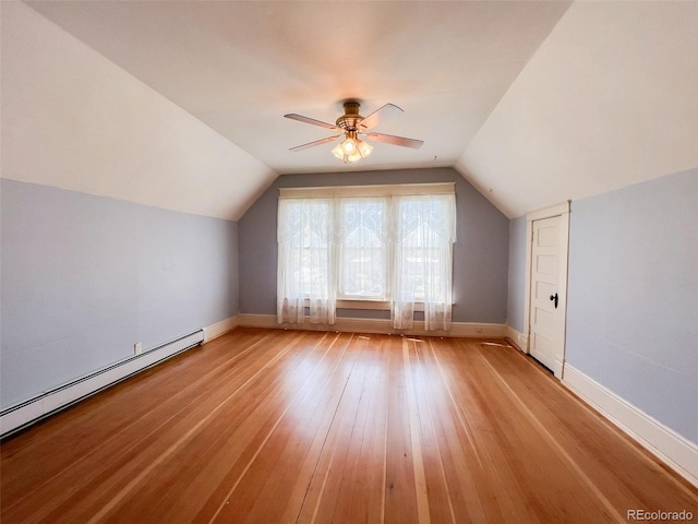 bonus room with light wood-type flooring, a baseboard radiator, vaulted ceiling, and ceiling fan