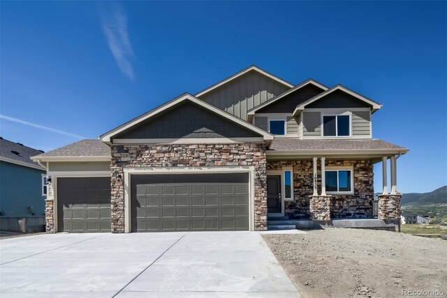 16858 Greyhawk Dr, Monument, CO 80132 - craftsman inspired home with a porch, a garage, driveway, and stone siding