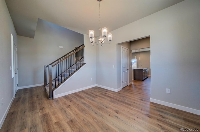 16858 Greyhawk Dr, Monument, CO 80132 - interior space featuring baseboards, stairs, wood finished floors, and a chandelier