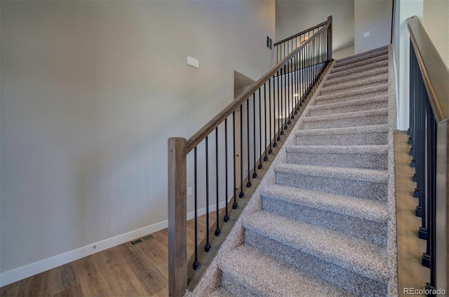 16858 Greyhawk Dr, Monument, CO 80132 - stairs with baseboards, a towering ceiling, wood finished floors, and visible vents