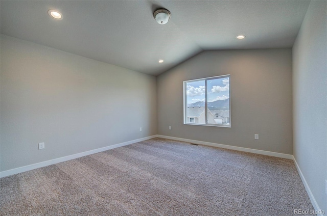 16858 Greyhawk Dr, Monument, CO 80132 - spare room featuring light carpet, recessed lighting, baseboards, lofted ceiling, and visible vents