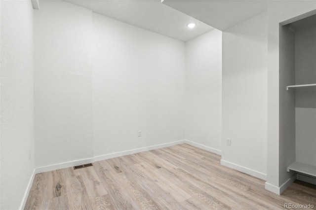 basement featuring wood finished floors, baseboards, and recessed lighting