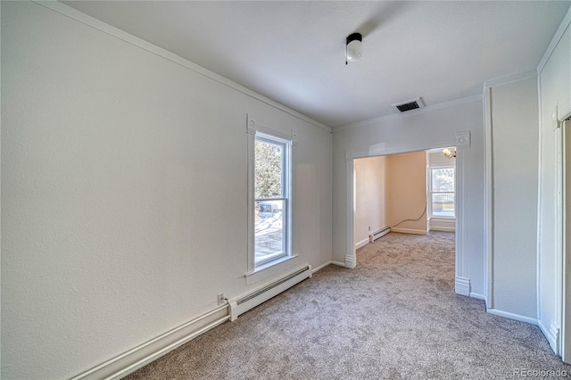 carpeted spare room featuring ornamental molding and a baseboard heating unit