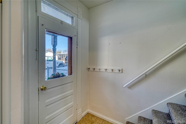 doorway with light tile patterned floors