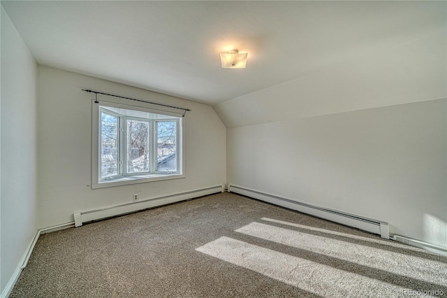 additional living space with carpet floors, vaulted ceiling, and a baseboard heating unit