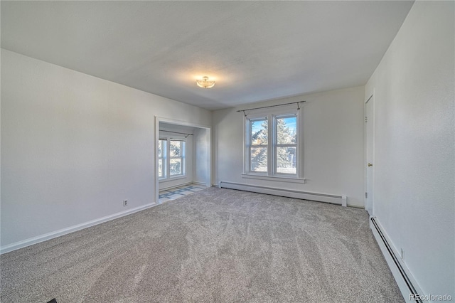 carpeted spare room with baseboard heating