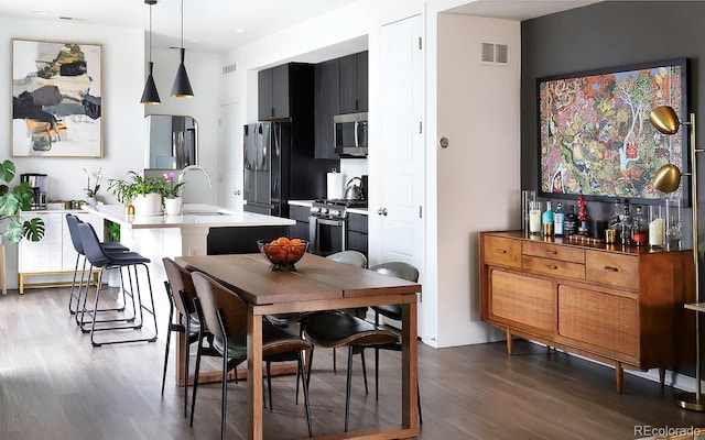 dining space featuring sink and dark hardwood / wood-style floors