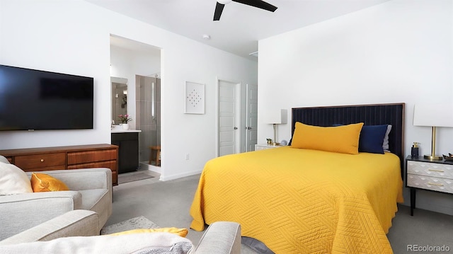 carpeted bedroom with ensuite bathroom, ceiling fan, and baseboards