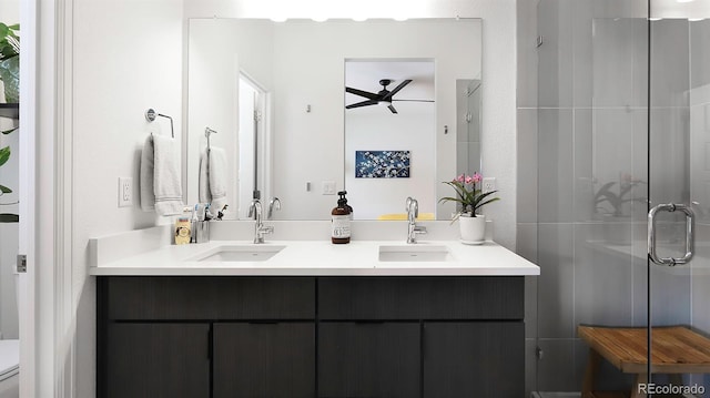 bathroom with double vanity, a sink, toilet, and a shower stall