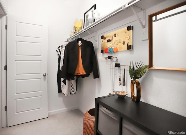 mudroom featuring carpet and baseboards