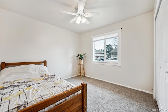 carpeted bedroom with a ceiling fan, baseboards, and a closet