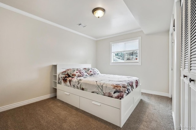 bedroom with crown molding, baseboards, dark carpet, and visible vents