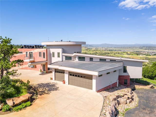 view of front of home with a mountain view and a garage