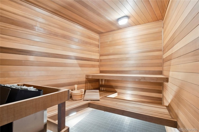 view of sauna featuring wooden walls, tile patterned flooring, and wood ceiling