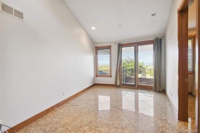 spare room with vaulted ceiling