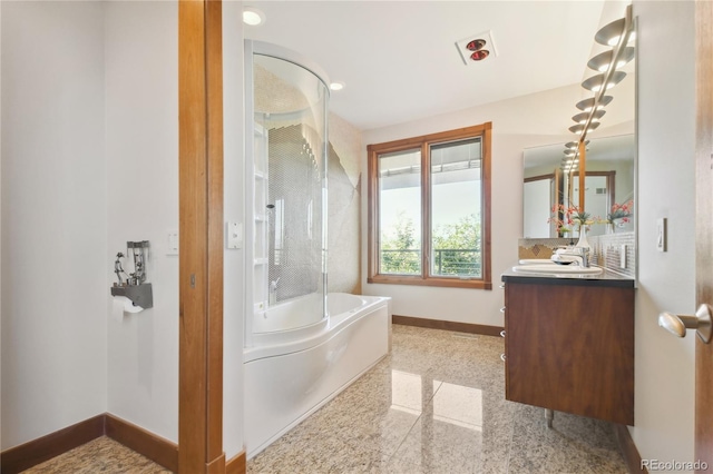 bathroom featuring vanity and a bath