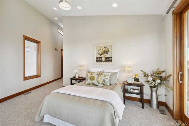 bedroom featuring light colored carpet and lofted ceiling