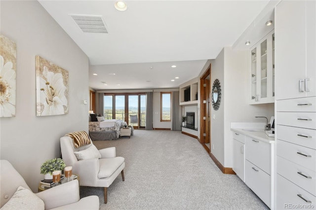 carpeted living room featuring sink