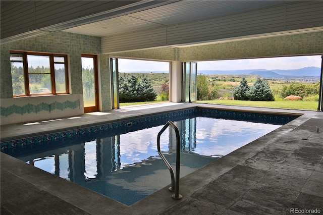 view of swimming pool with a mountain view