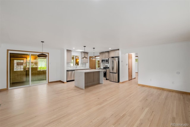 6994 Teller Ct, Arvada, CO 80003 - kitchen featuring stainless steel appliances, a center island, light wood-type flooring, open floor plan, and recessed lighting