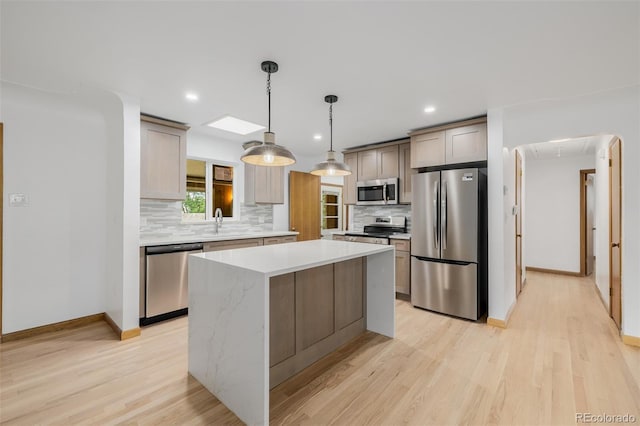 6994 Teller Ct, Arvada, CO 80003 - kitchen featuring appliances with stainless steel finishes, decorative backsplash, light wood-style floors, a center island, and recessed lighting