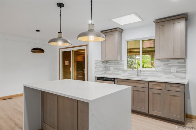 6994 Teller Ct, Arvada, CO 80003 - kitchen featuring backsplash, light wood-style floors, stainless steel dishwasher, a center island, and light countertops