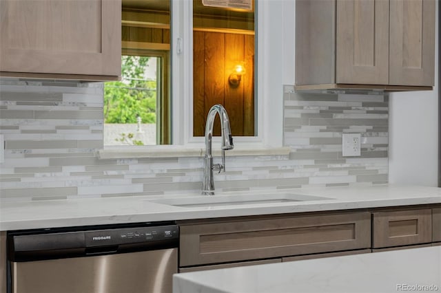 6994 Teller Ct, Arvada, CO 80003 - kitchen with stainless steel dishwasher, tasteful backsplash, and light stone countertops
