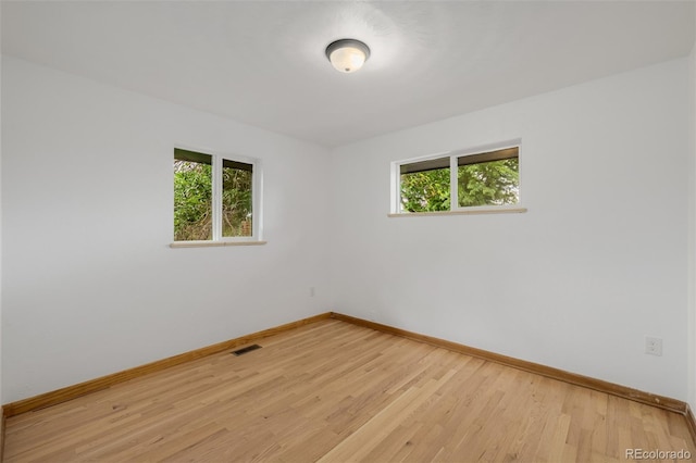 6994 Teller Ct, Arvada, CO 80003 - empty room featuring healthy amount of natural light and light wood-type flooring