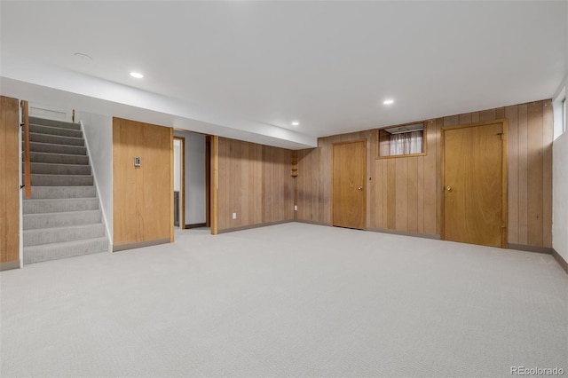 6994 Teller Ct, Arvada, CO 80003 - finished basement with wood walls, light colored carpet, stairs, and recessed lighting
