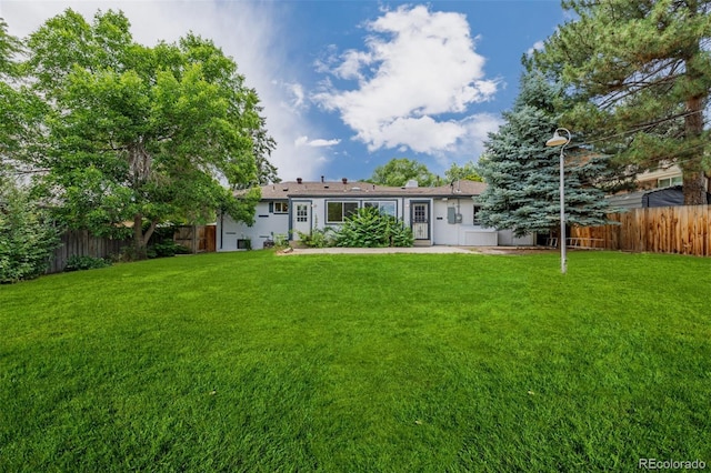 6994 Teller Ct, Arvada, CO 80003 - back of house with a fenced backyard