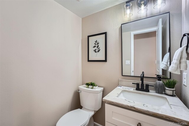 half bath with vanity and toilet