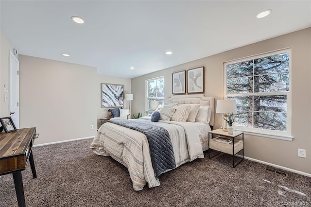 bedroom with dark colored carpet, visible vents, baseboards, and recessed lighting