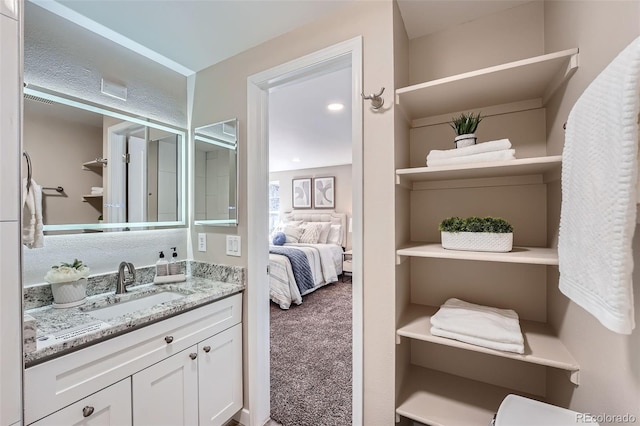 ensuite bathroom with vanity and ensuite bath