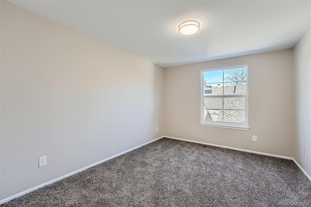 carpeted empty room with baseboards