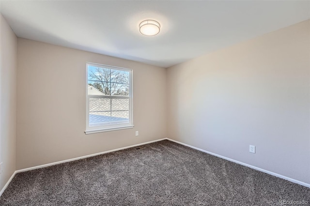 empty room featuring baseboards and carpet flooring