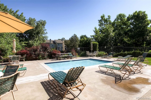 community pool featuring a patio area and fence