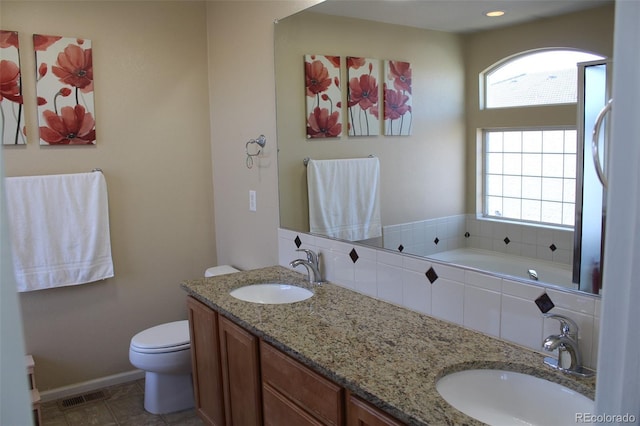 bathroom with vanity, toilet, tile patterned floors, and a tub to relax in